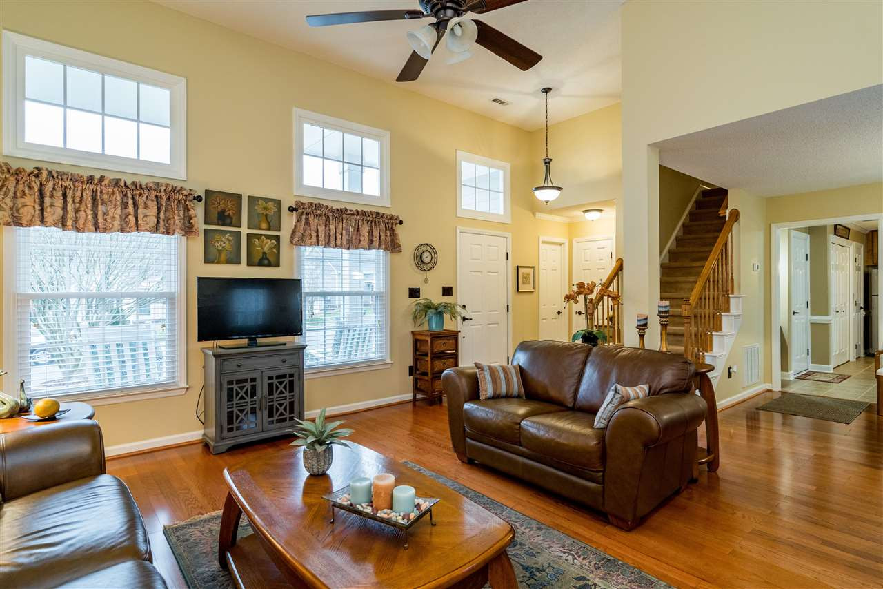 5213 Denmead Way Raleigh, NC 27613 - Photo 7 of 25 a living room with fireplace furniture and a flat screen tv