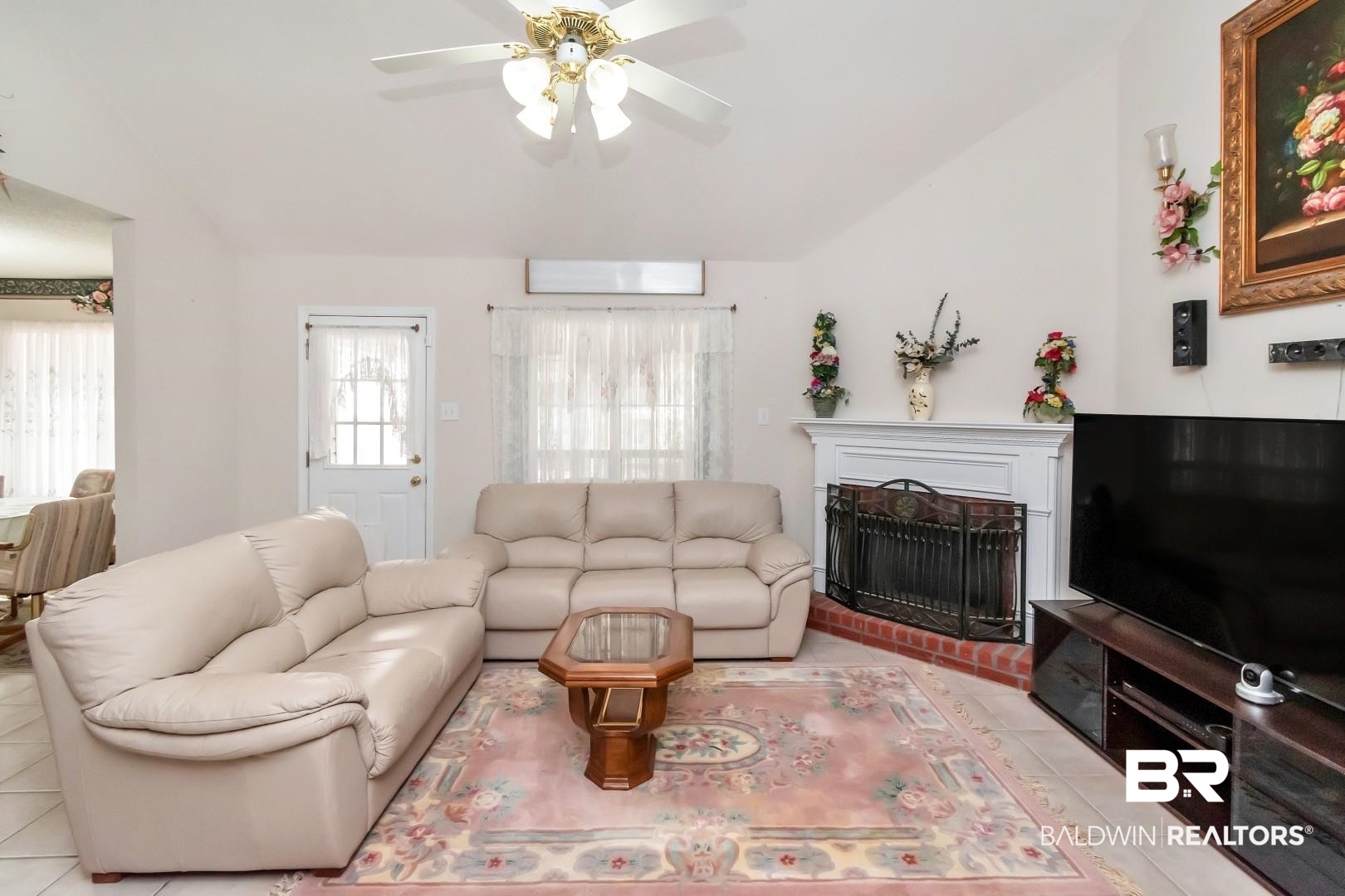 8221 Woodbend Drive Semmes, AL 36575 - Photo 9 of 35 Tiled living room with ceiling fan and a brick fireplace