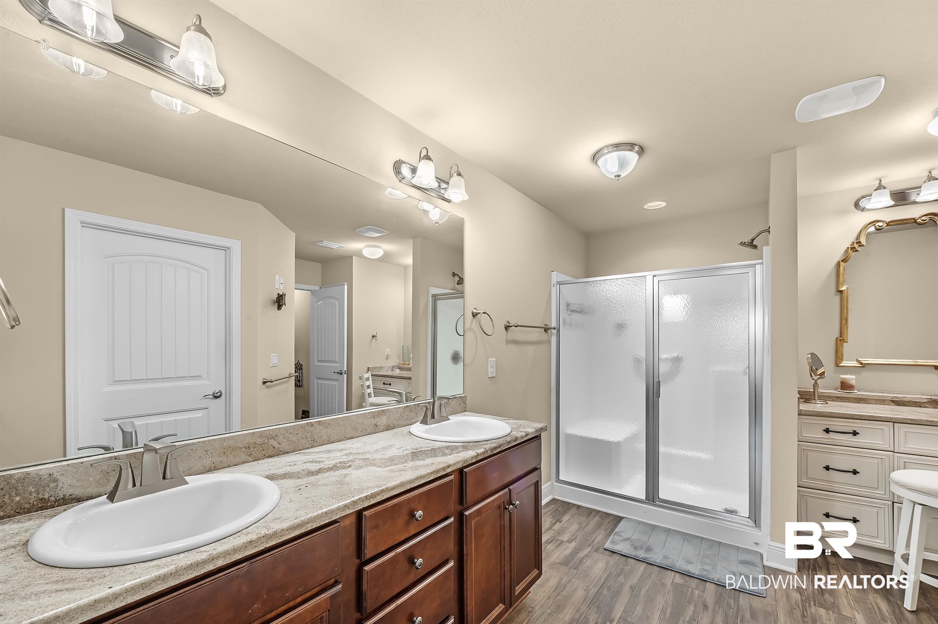 8896 Allay Lane Foley, AL 36535 - Photo 46 of 57 Bathroom with vanity, hardwood / wood-style flooring, and walk in shower