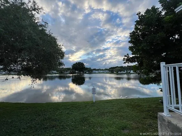 a view of a lake with houses in the back