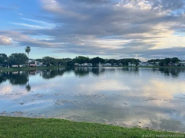 a view of kitchen and hall with wooden floor