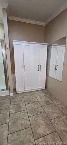 a bathroom with a sink a toilet a mirror a vanity and shower