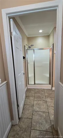 a living room with furniture and a air conditioner vent