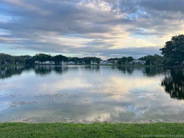 a view of a house with backyard and a garden