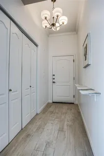 a view of a room with an empty space and a ceiling fan