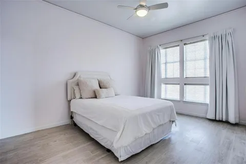a large bed sitting in a bedroom next to a window