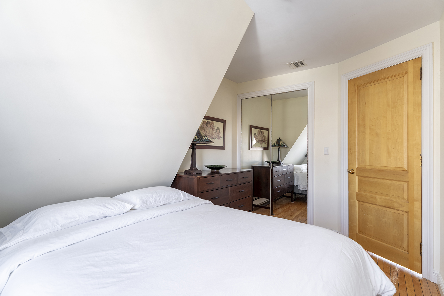 68-23 Exeter Street, Unit 2 Queens, NY 11375 - Photo 12 of 15 a bedroom with a bed and wooden floor