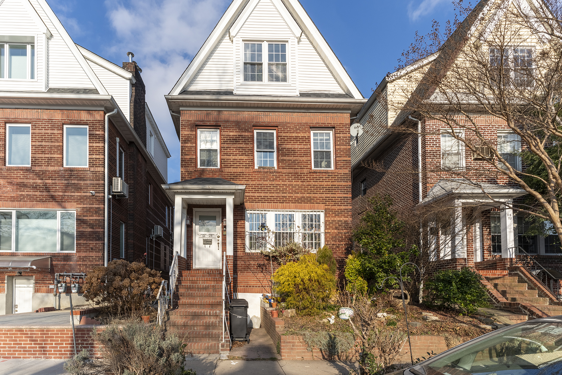 68-23 Exeter Street, Unit 2 Queens, NY 11375 - Photo 15 of 15 a front view of a house with garden