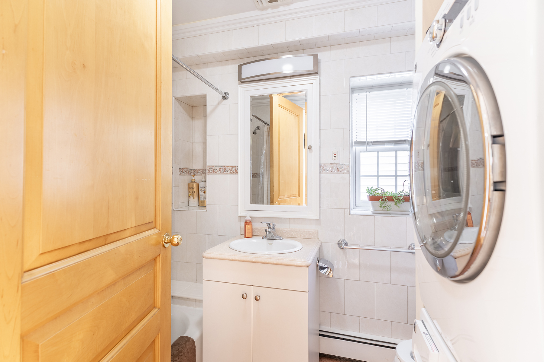 68-23 Exeter Street, Unit 2 Queens, NY 11375 - Photo 7 of 15 a bathroom with a sink a vanity and a mirror