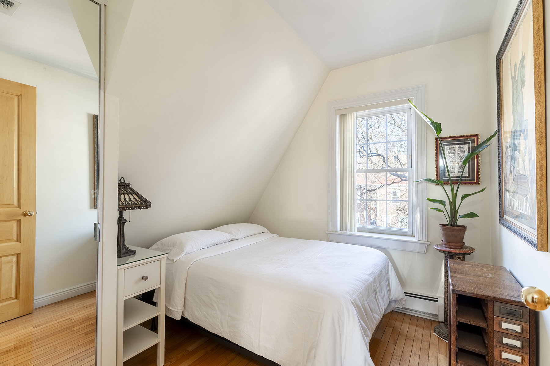 68-23 Exeter Street, Unit 2 Queens, NY 11375 - Photo 9 of 15 a bedroom with a bed and a large window with wooden floor