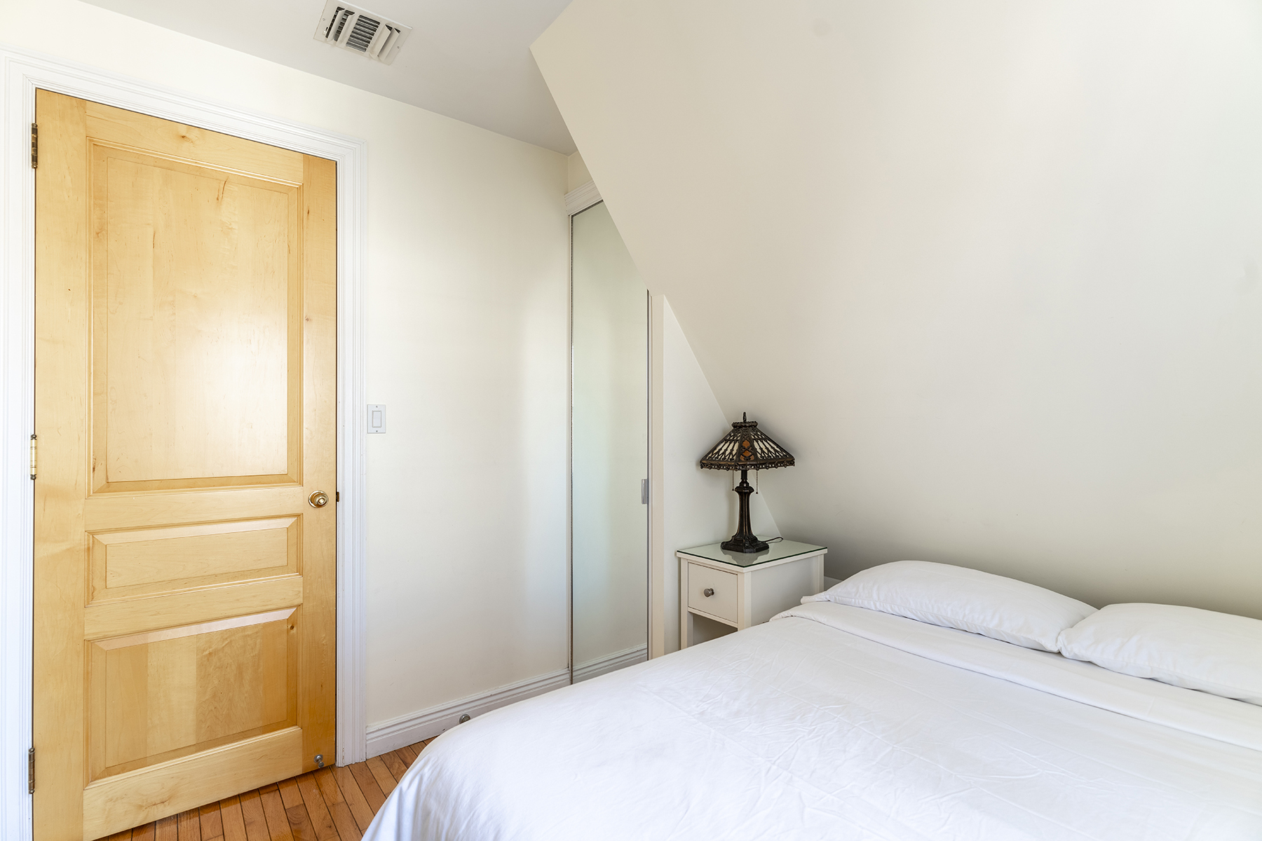 68-23 Exeter Street, Unit 2 Queens, NY 11375 - Photo 10 of 15 a bedroom with a bed and a cabinets