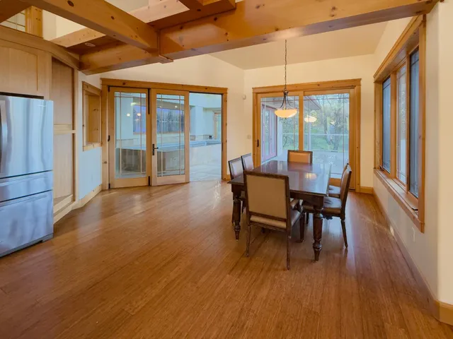 a dining room with furniture and wooden floor
