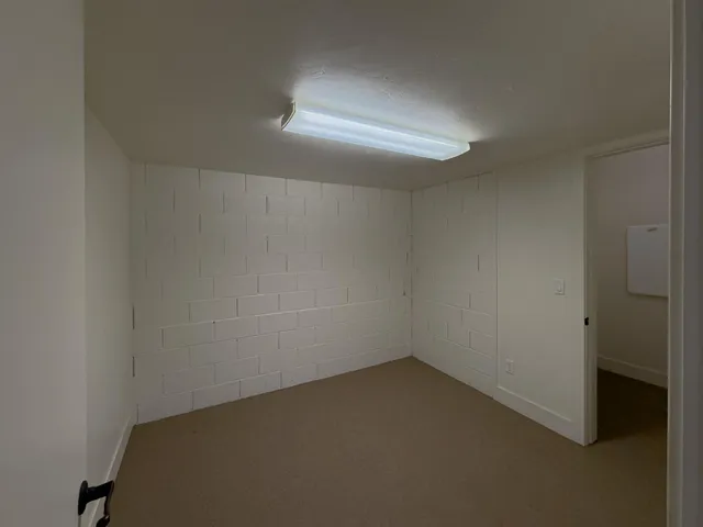 a view of an empty room with glass door