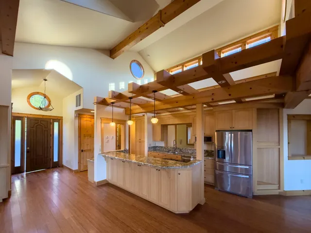 a view of a kitchen with furniture and wooden floor