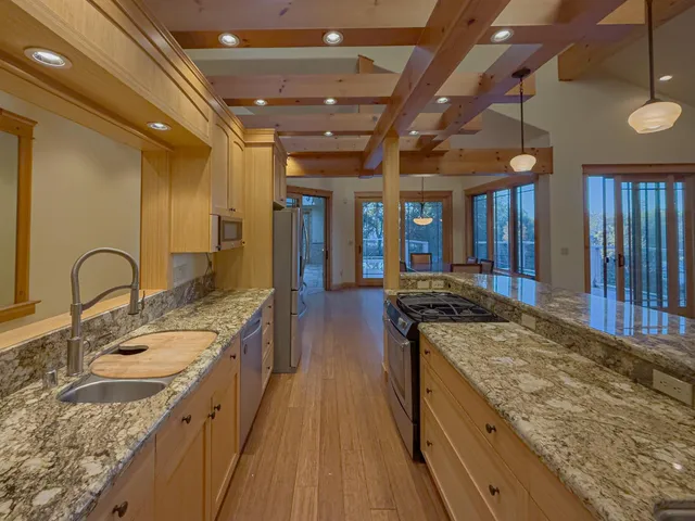 a large kitchen with a stove and a sink