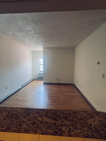 a view of a room with wooden floor
