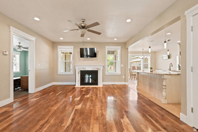580 North 300 East Logan, UT 84321 - Photo 27 of 74 Spacious living area featuring wood-finish flooring, a fireplace with a white mantel, and recessed lighting