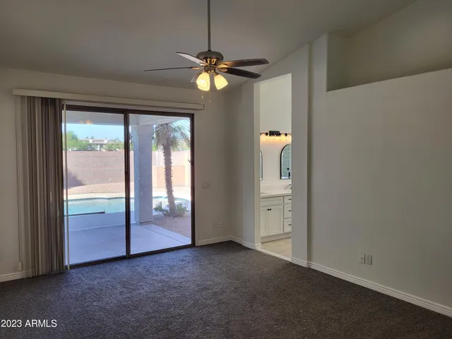 an empty room that has windows and painted walls