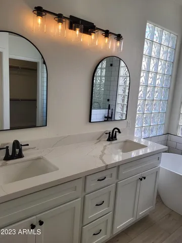 a bathroom with a double vanity sink and a mirror