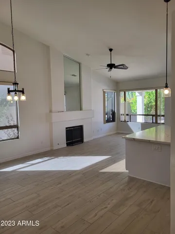 a view of an empty room with a fireplace and a window