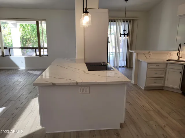 a kitchen view with wooden floor and window