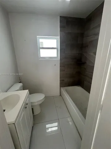 a bathroom with a sink a toilet and bathtub