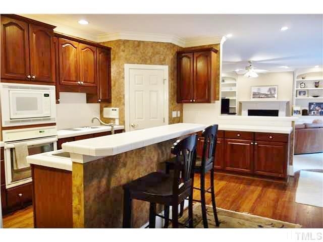 11320 Honeycutt Road, Unit LOT12 Raleigh, NC 27614 - Photo 3 of 25 Enormous kitchen has hardwood floors, tile c/tops, a corner pantry, & is open to the family room for easy entertaining.