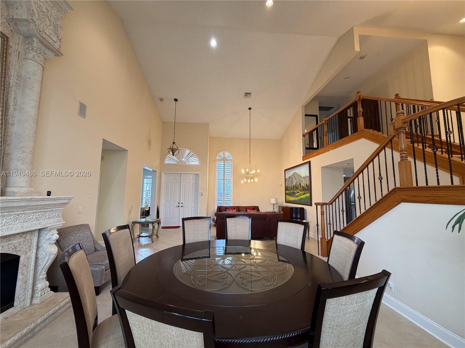 3279 Huntington Weston, FL 33332 - Photo 13 of 40 a dining room with furniture a rug and wooden floor