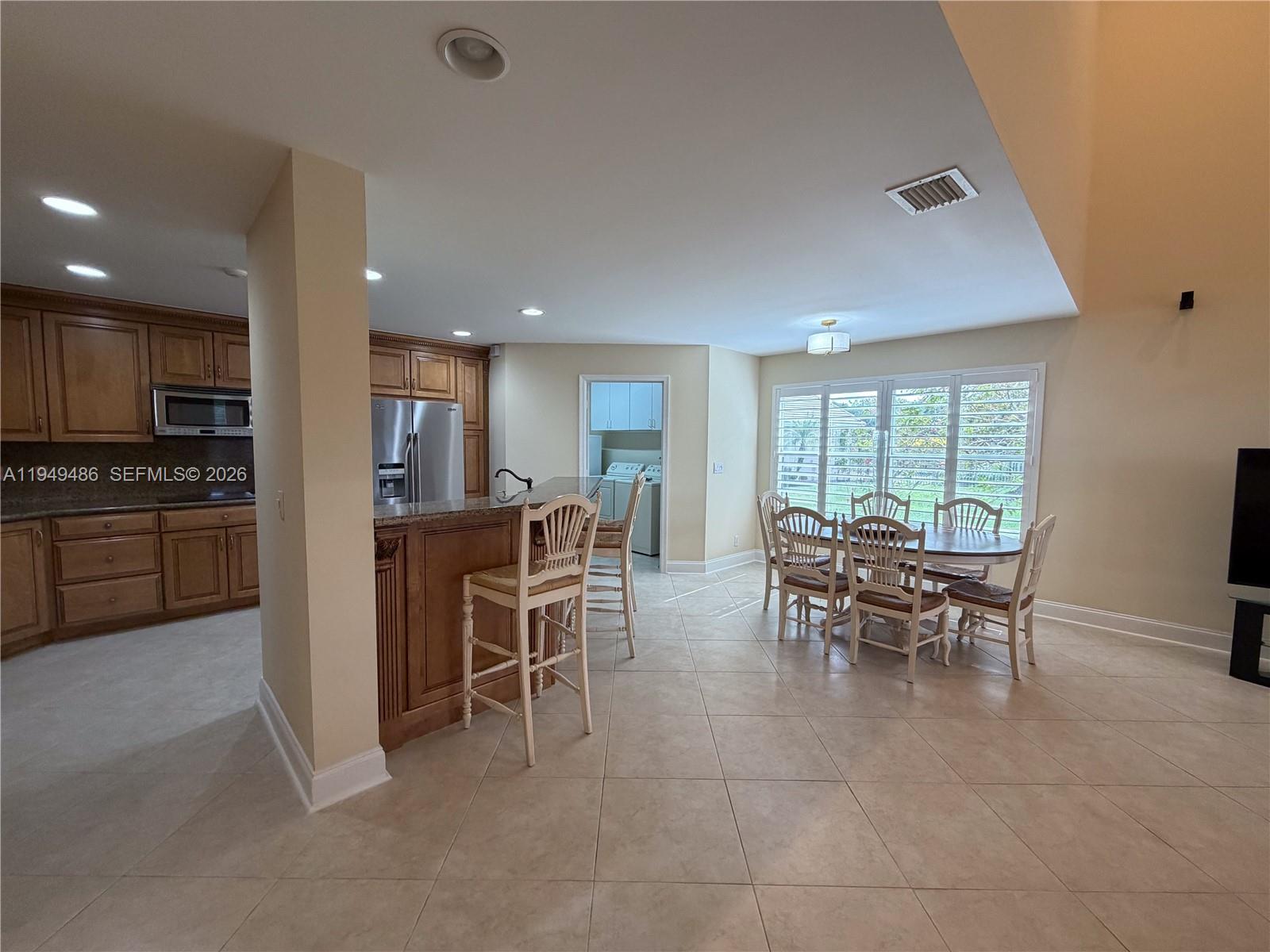 3279 Huntington Weston, FL 33332 - Photo 15 of 40 a view of a dining room with furniture and a kitchen