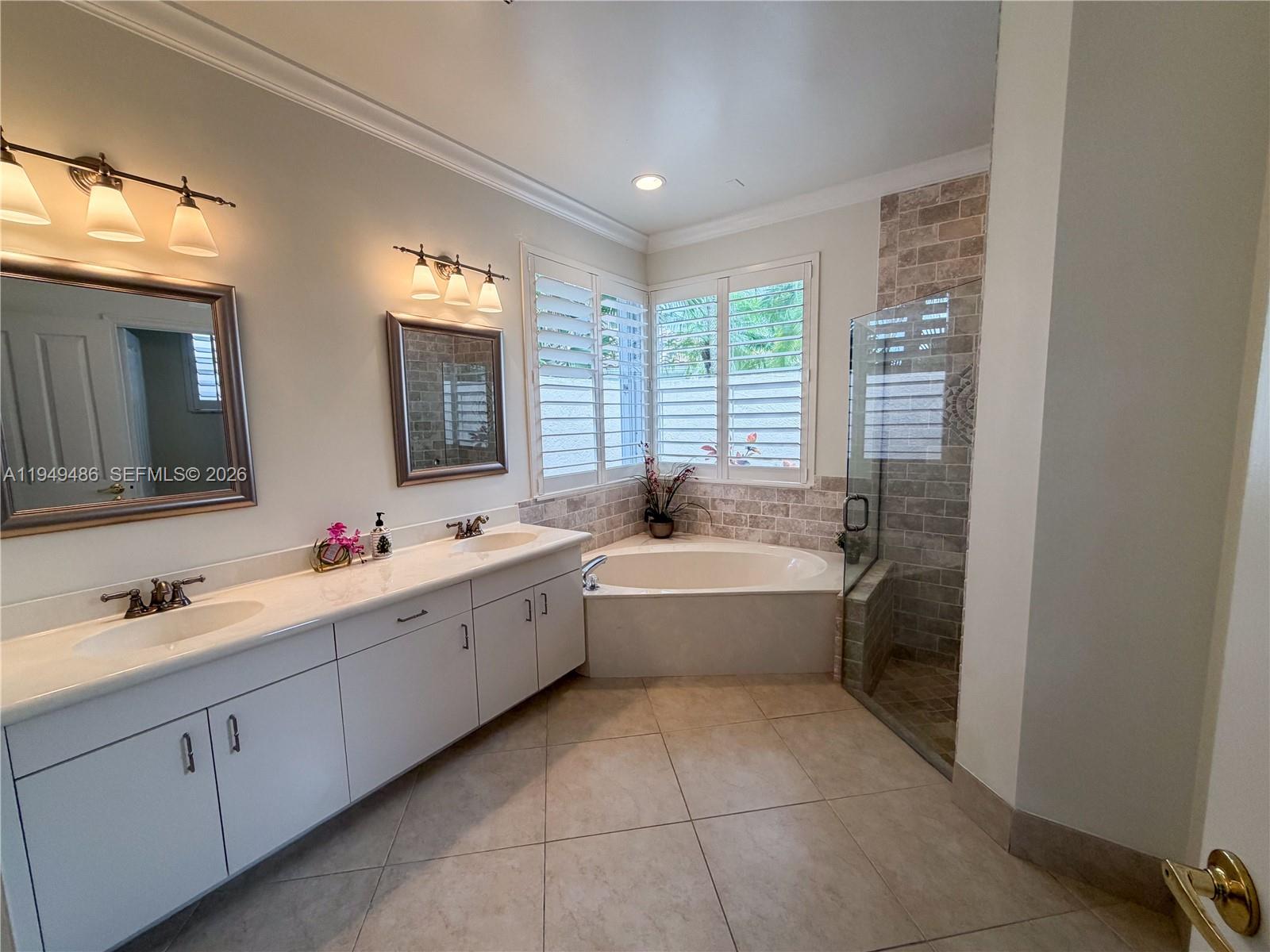 3279 Huntington Weston, FL 33332 - Photo 17 of 40 a large white bathroom with a large tub sink shower and mirror