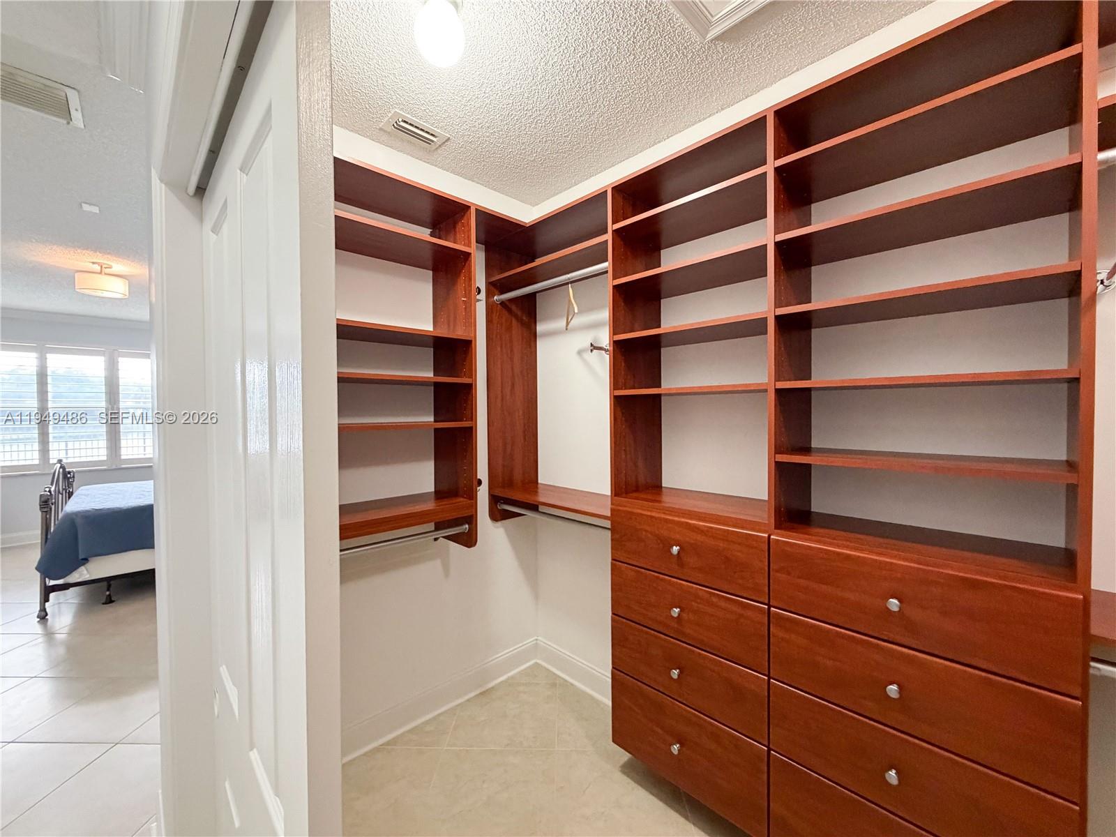 3279 Huntington Weston, FL 33332 - Photo 18 of 40 a view of walk in closet with clothes and shoes