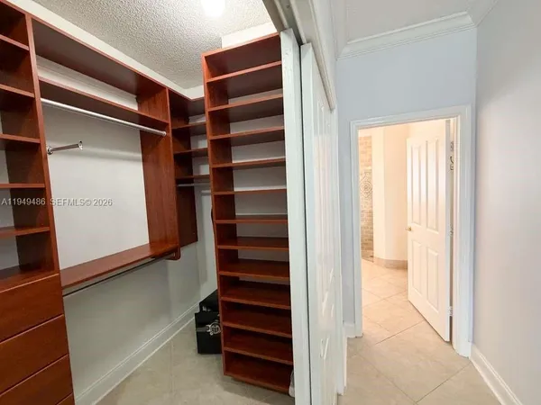 a view of walk in closet with empty racks