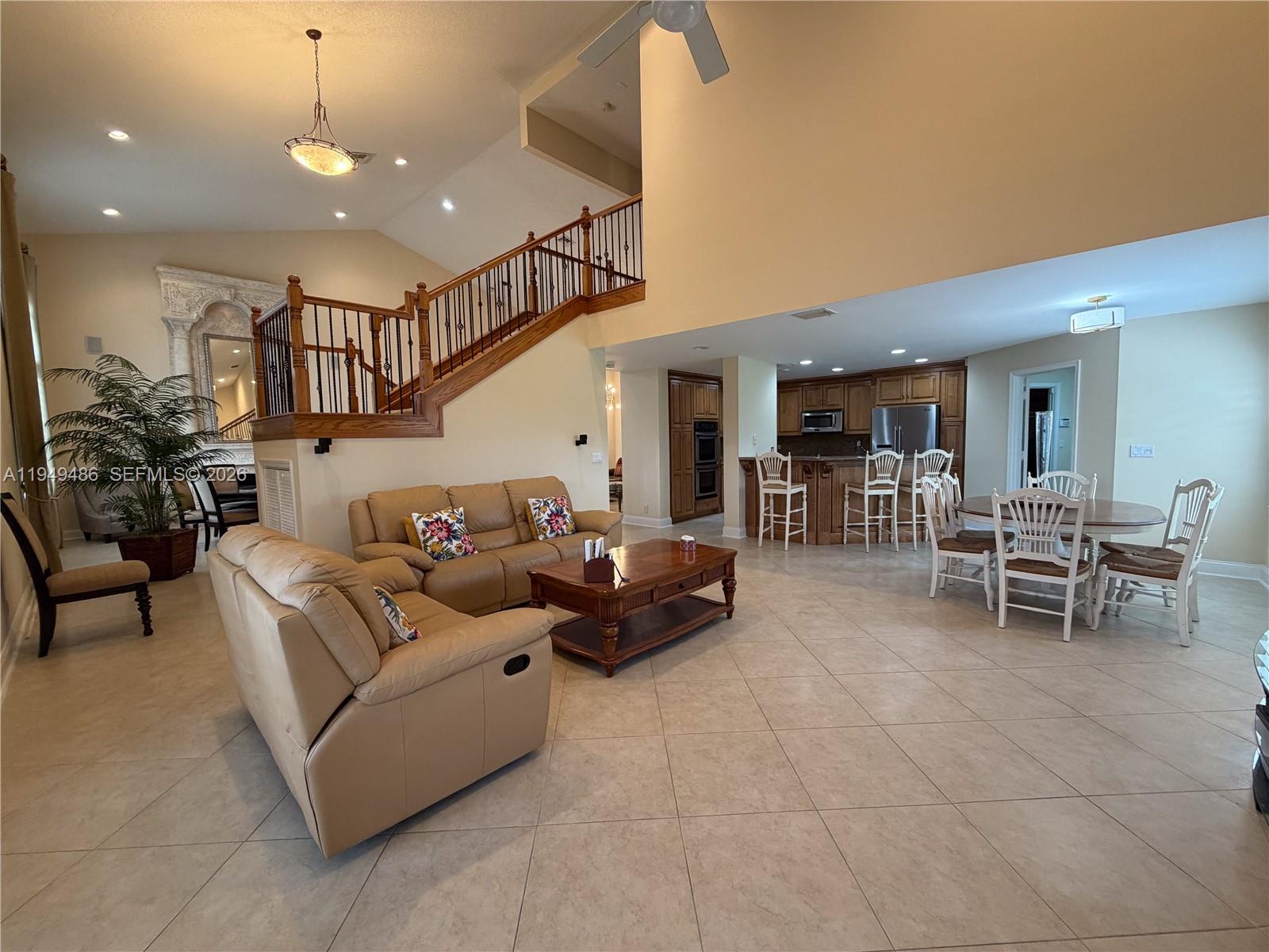 3279 Huntington Weston, FL 33332 - Photo 20 of 40 a living room with furniture and a dining table with kitchen view