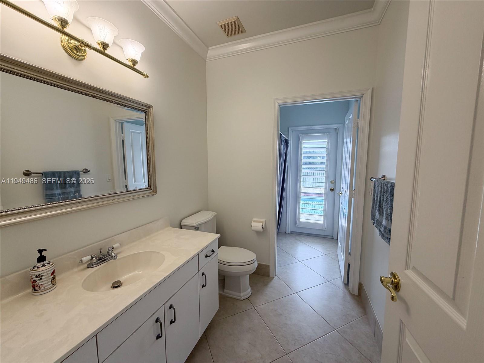 3279 Huntington Weston, FL 33332 - Photo 21 of 40 a bathroom with a double vanity sink toilet and mirror