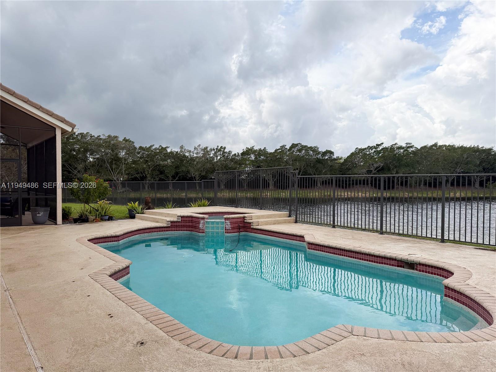 3279 Huntington Weston, FL 33332 - Photo 32 of 40 a view of a swimming pool with a lounge chair