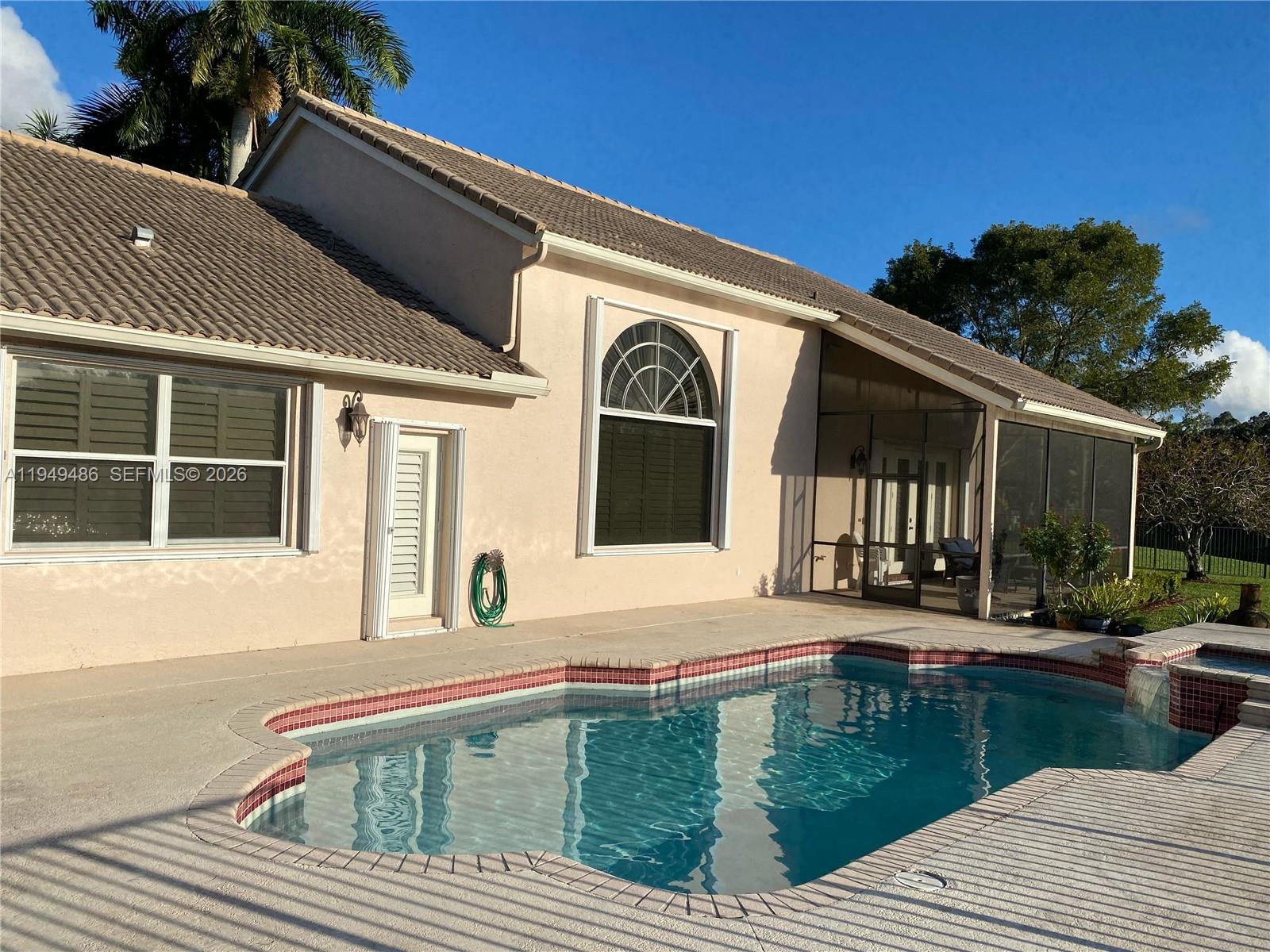 3279 Huntington Weston, FL 33332 - Photo 33 of 40 a front view of a house with garden