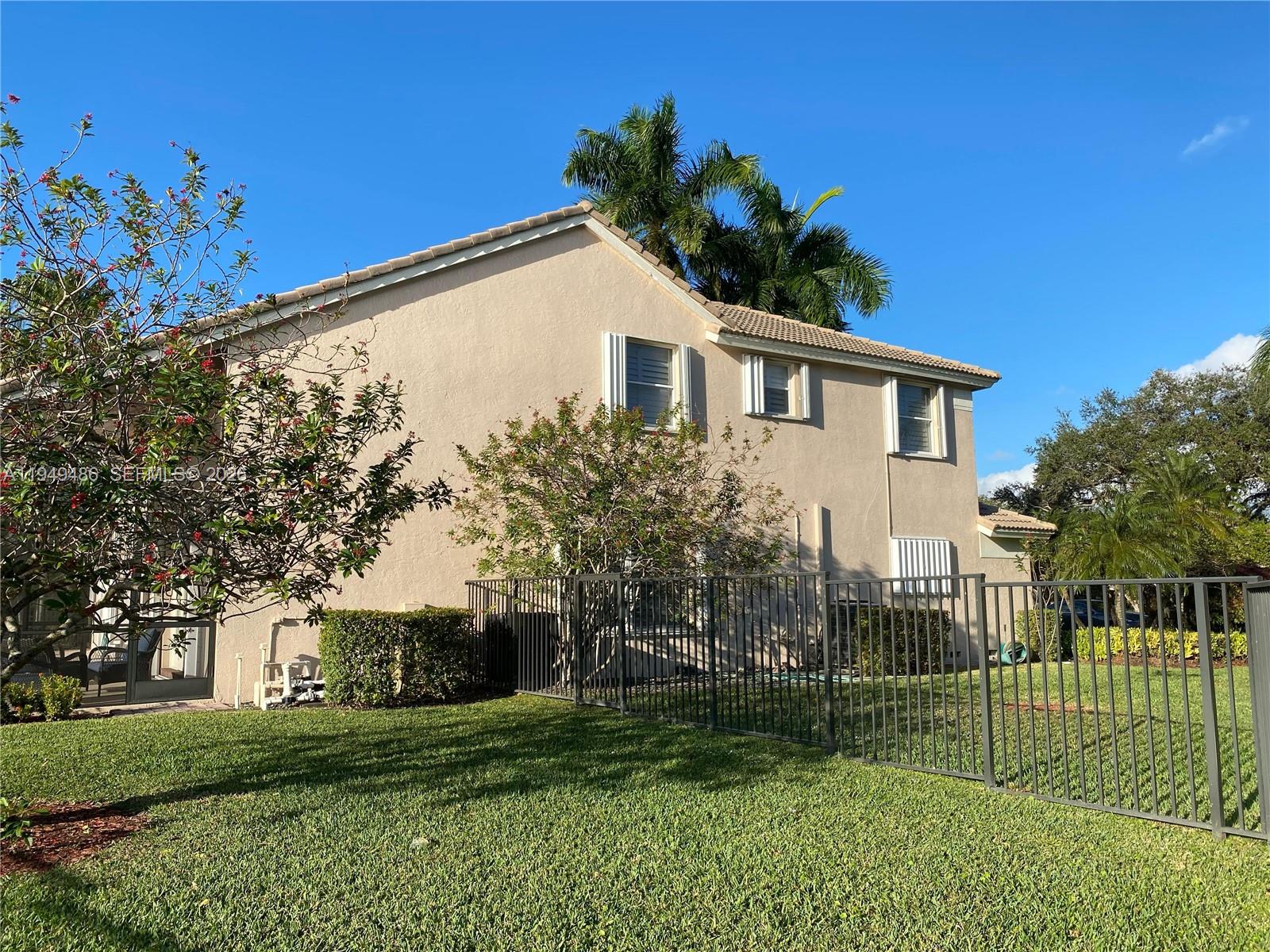 3279 Huntington Weston, FL 33332 - Photo 38 of 40 a front view of a house with a garden