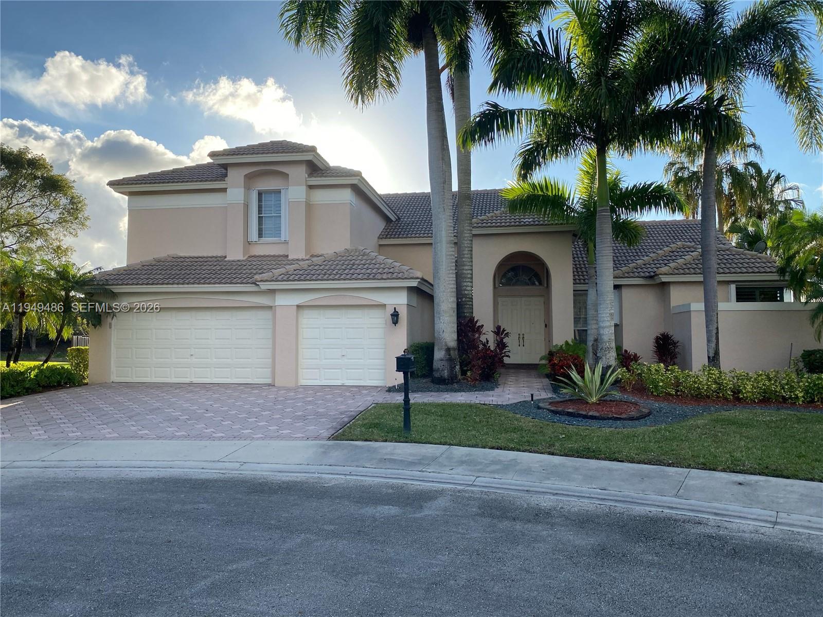 3279 Huntington Weston, FL 33332 - Photo 4 of 40 a front view of house with yard and green space