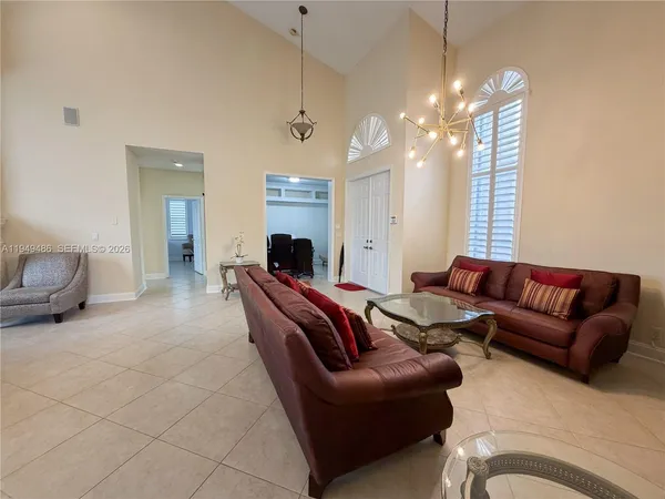 a living room with furniture and a chandelier