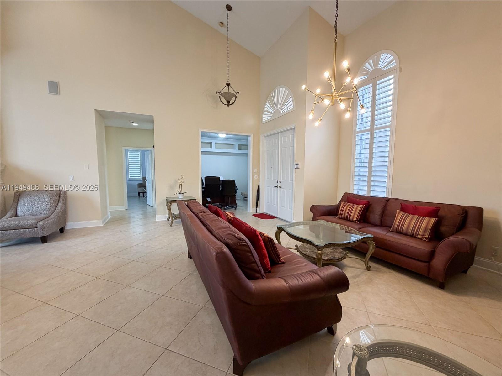 3279 Huntington Weston, FL 33332 - Photo 5 of 40 a living room with furniture and a chandelier