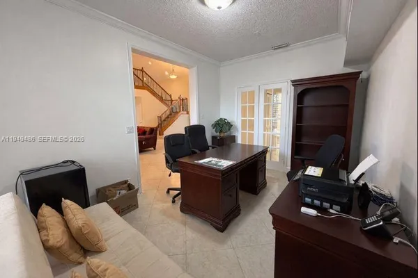 a living room with furniture a flat screen tv and a window