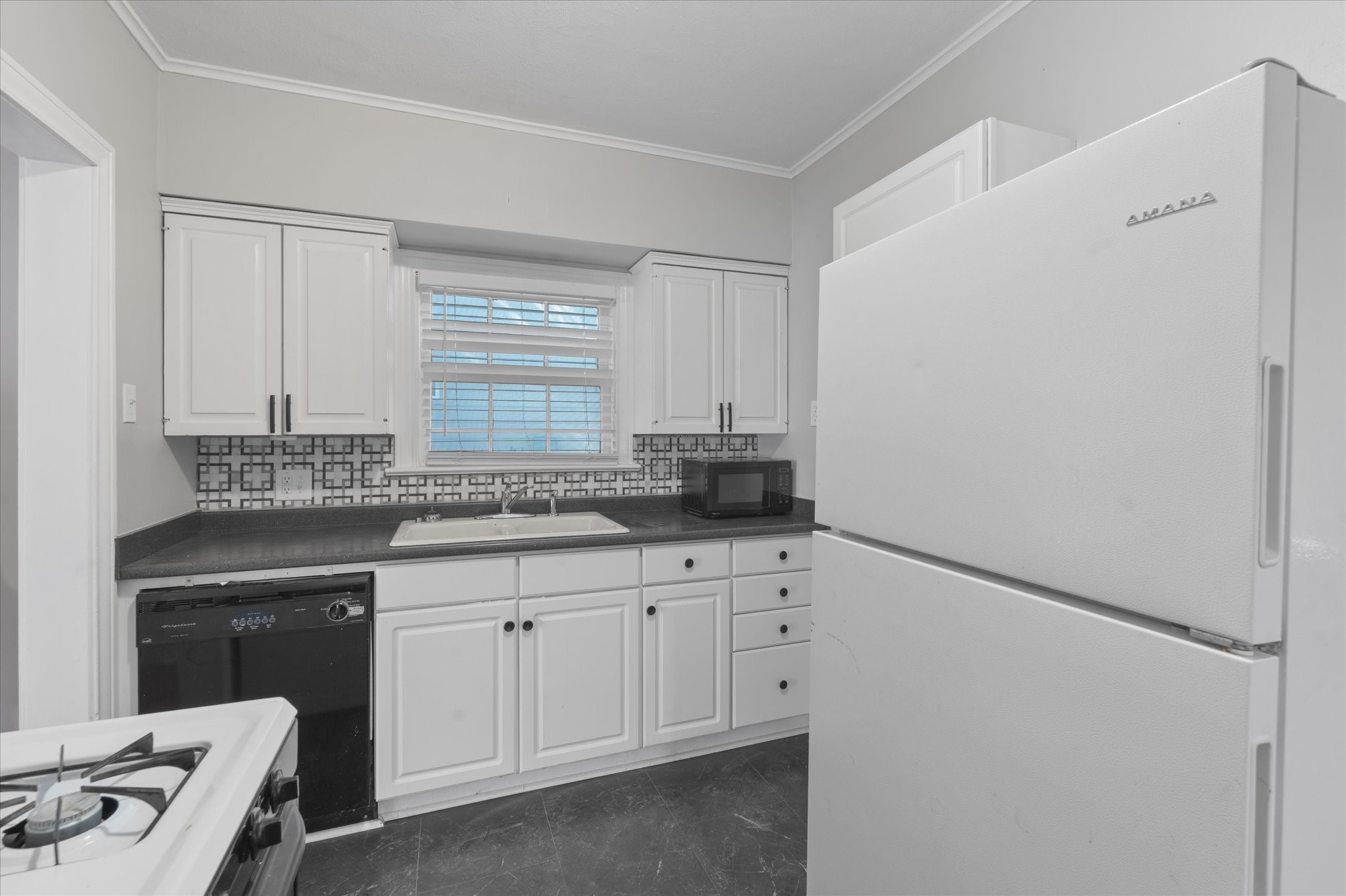 4337 Jefferson Street, Unit 1 Houston, TX 77023 - Photo 6 of 13 a kitchen with white cabinets and sink