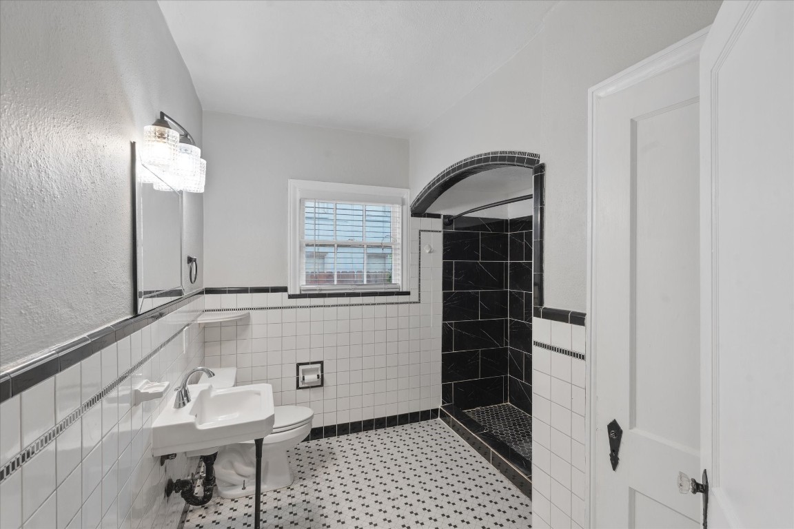4337 Jefferson Street, Unit 1 Houston, TX 77023 - Photo 9 of 13 a bathroom with a sink a toilet and shower