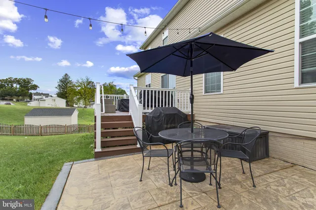 a table and chairs in patio of the house