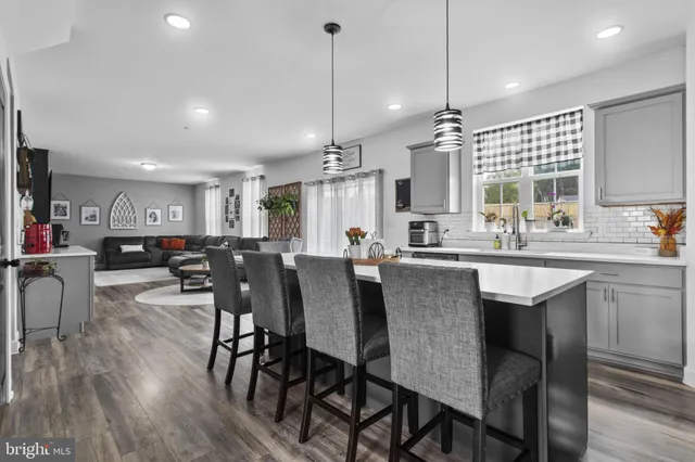a large kitchen with a table and chairs