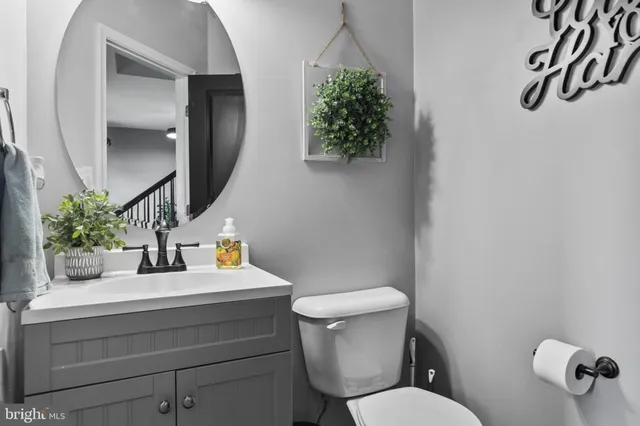 a bathroom with a toilet sink and mirror