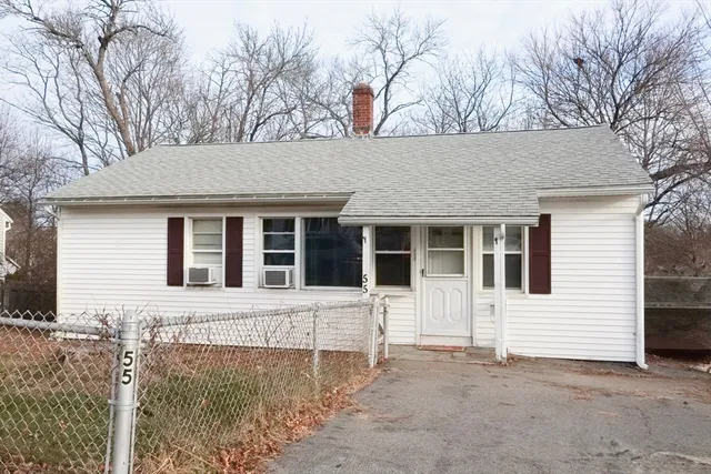 a living room with furniture rug and a window