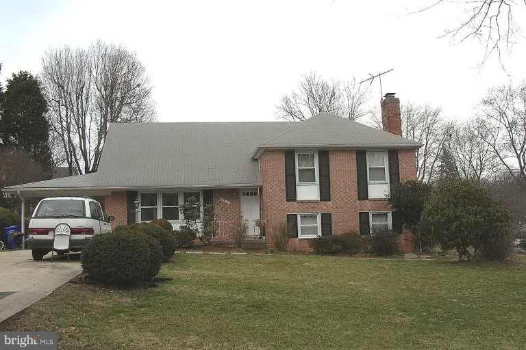 516 Elderwood Road Silver Spring, MD 20904 - Photo 1 of 1 a front view of a house with a garden