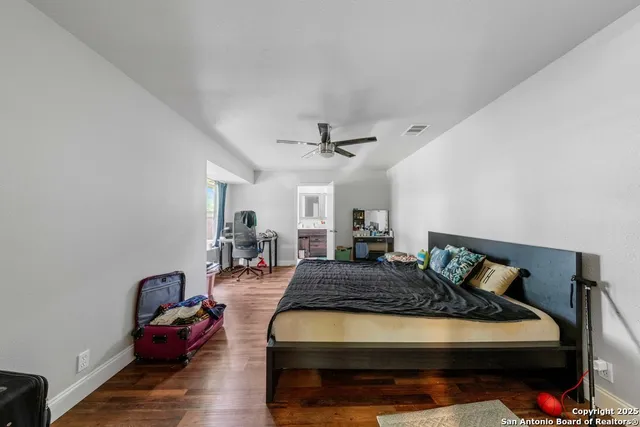 a bedroom with furniture and wooden floor