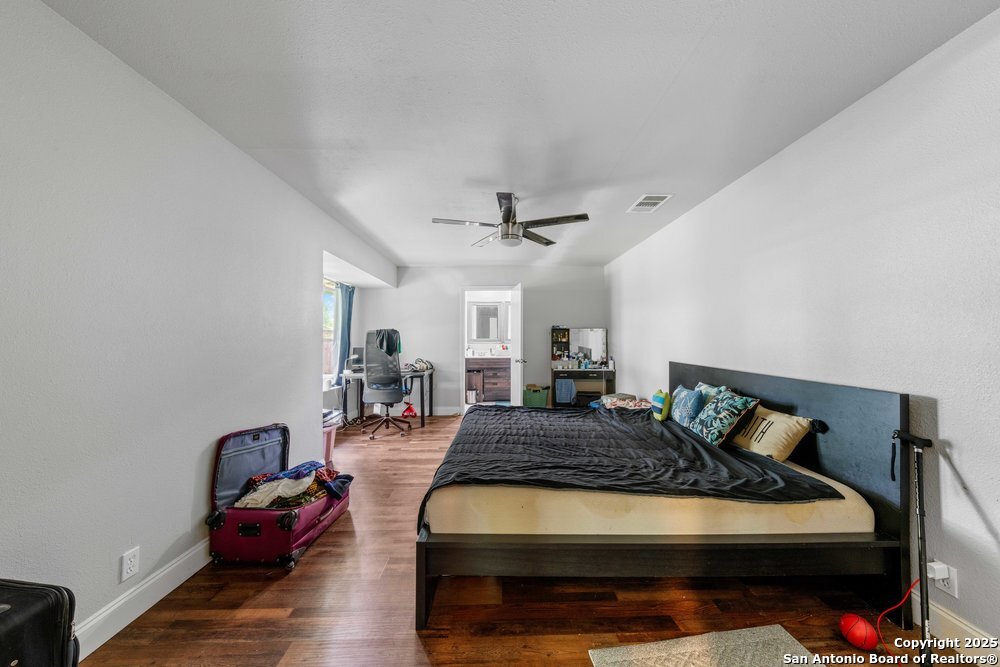 7131 Apache Converse, TX 78109 - Photo 11 of 14 a bedroom with furniture and wooden floor